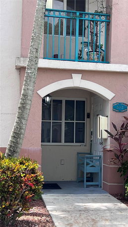 Front view of a two-story house with a small balcony and entrance.