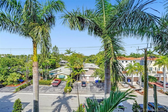 View from a higher elevation showing a neighborhood with palm trees and various residential buildings.