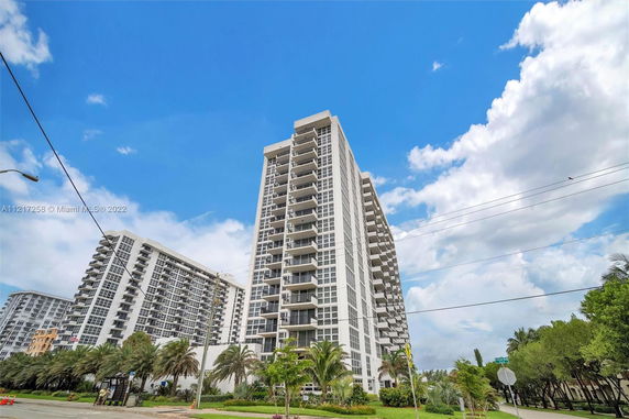Front view of a high-rise residential building with balconies.