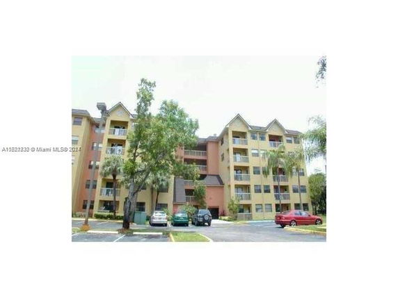Front view of a multi-story apartment building with balconies.
