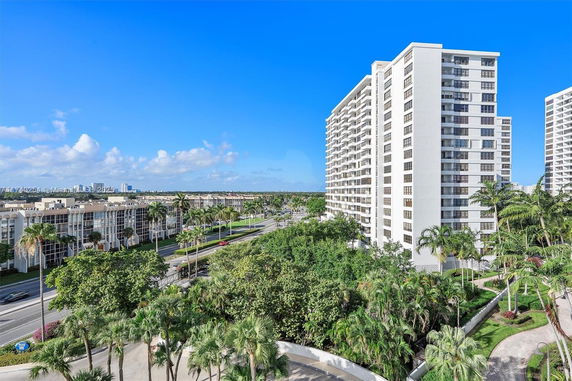 View of high-rise residential buildings and surrounding area with roads and trees.