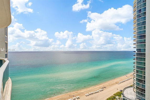 Panoramic view from a building overlooking the ocean and beach.