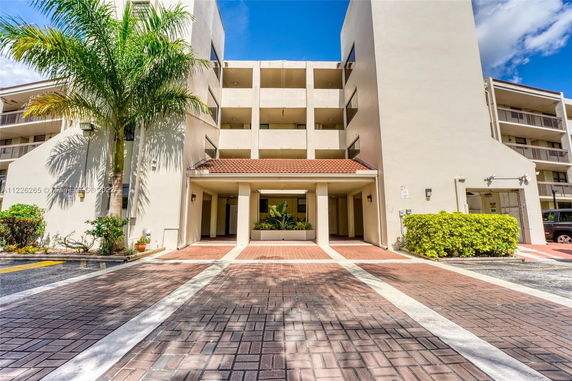 Front view of a multi-story building with balconies.