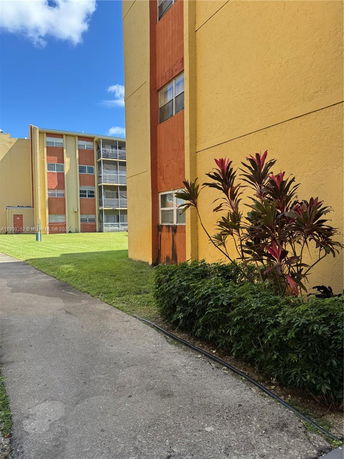 Side view of a multistory residential building with colorful exterior.