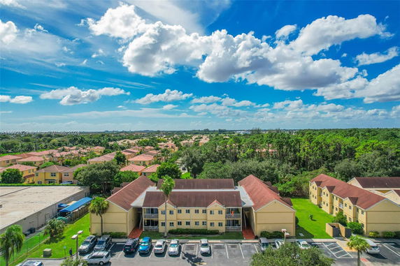 Aerial view of a residential area with multiple houses and lush greenery.