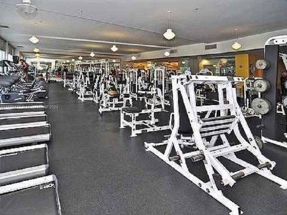 Spacious gym area with various exercise machines and equipment.