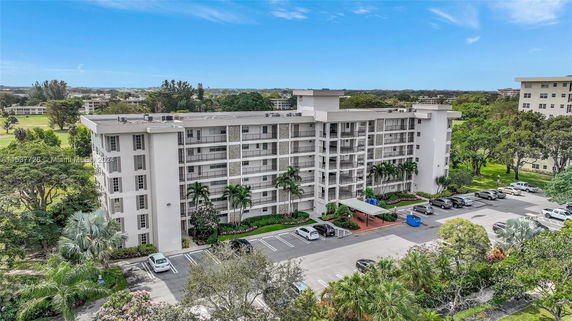 Front view of a multi-story residential building with balconies.