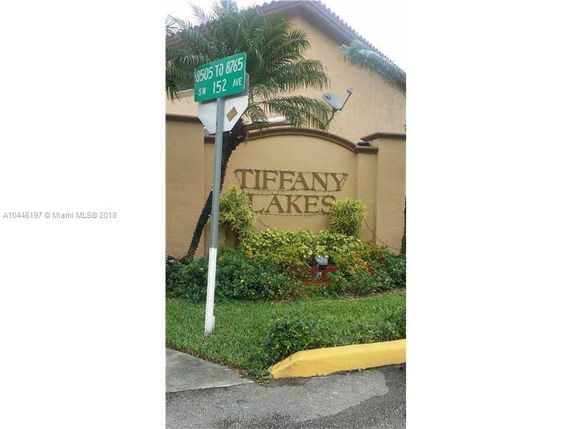 Front view of a building with 'Tiffany Lakes' signage on a wall.