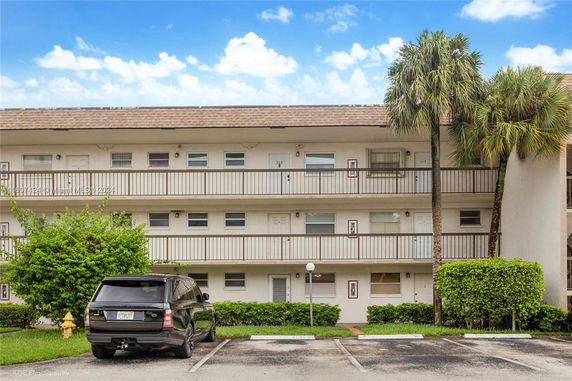 Front view of a multi-story residential building with balconies.