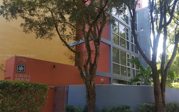 Front view of a multi-story building with large windows and a colorful facade.