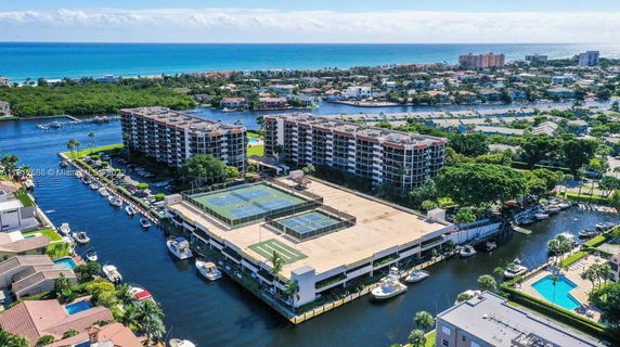 Panoramic view of residential buildings with tennis courts on the rooftop.