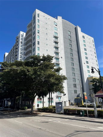 Front view of a multi-story residential building with balconies.