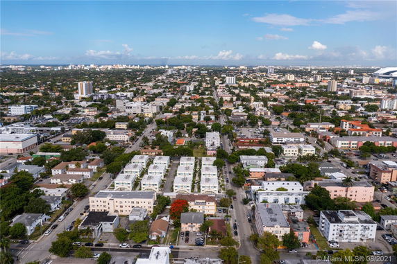 Aerial panoramic view of a dense urban area with numerous buildings and streets.