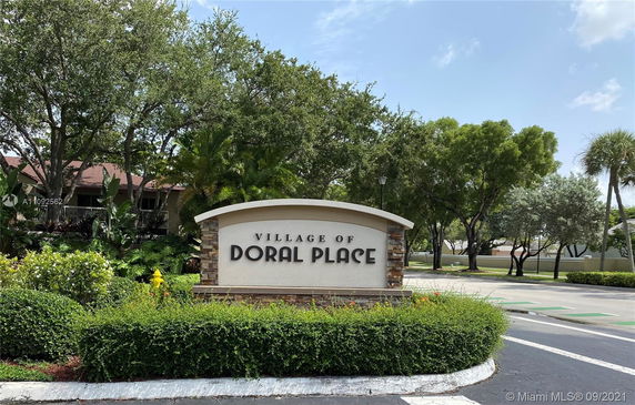 Entrance signage of a residential area named 'Village of Doral Place.'