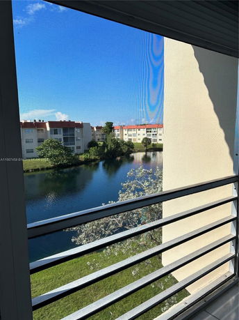 View of multiple apartment buildings across a pond.