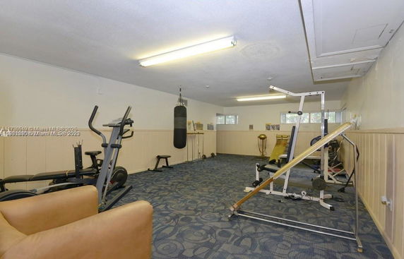 Indoor gym area with exercise equipment and a punching bag.
