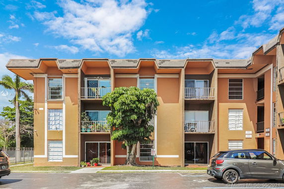 Front view of a multi-story residential building with balconies.