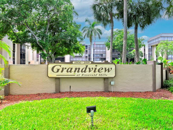 Front view of a multi-story building complex with a sign reading 'Grandview at Emerald Hills'.