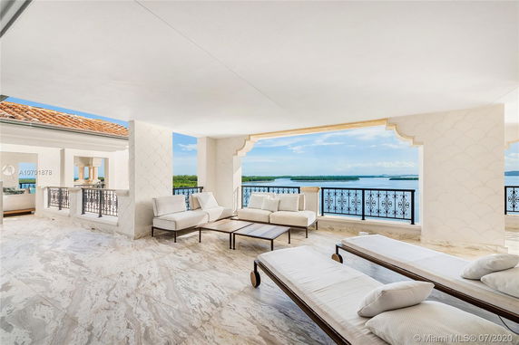 Open terrace area with outdoor seating overlooking a waterfront view.