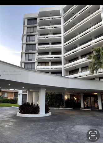 Front view of a multi-story residential building with balconies.