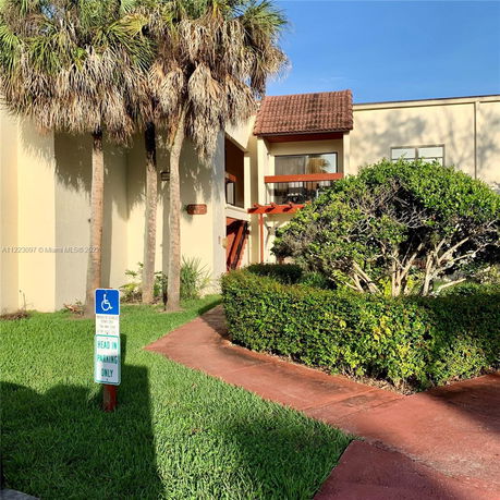 Front view of a building with a tiled roof and entrance walkway.