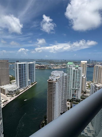 Panoramic view of cityscape with high-rise buildings and waterway