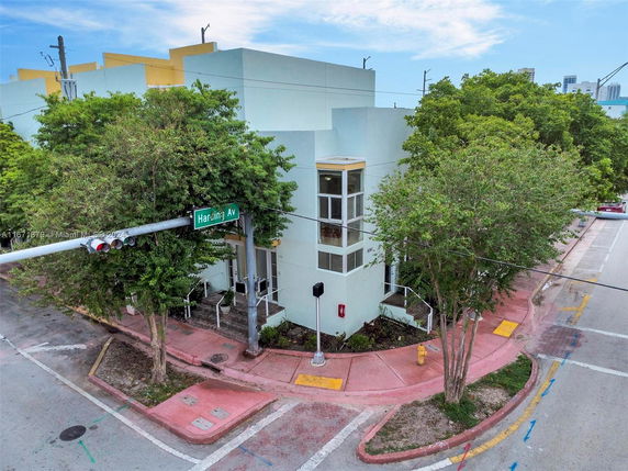 Front view of a two-story modern building on a street corner.