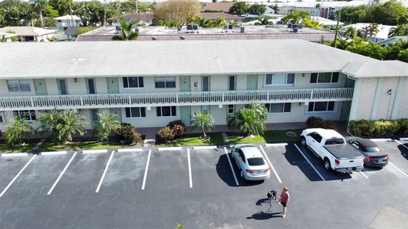 Parking area in front of a two-story residential building.