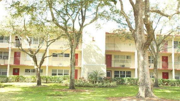Front view of a multi-story residential building with balconies.