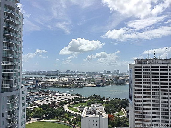 Panoramic view of a cityscape with water and surrounding buildings.