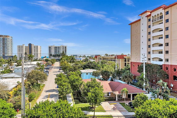 View of residential area with multi-story buildings and a clear blue sky.