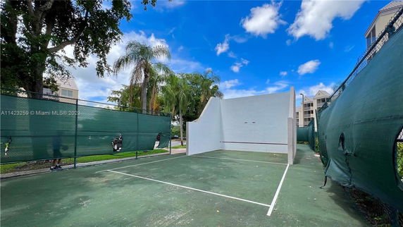 Outdoor sports court with a high wall for ball games.