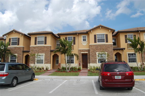 Front view of a two-story townhouse with stone and stucco exterior.