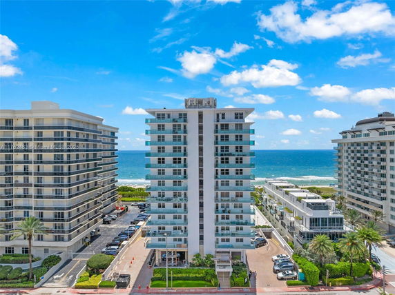 Front view of a mid-rise residential building near the ocean.