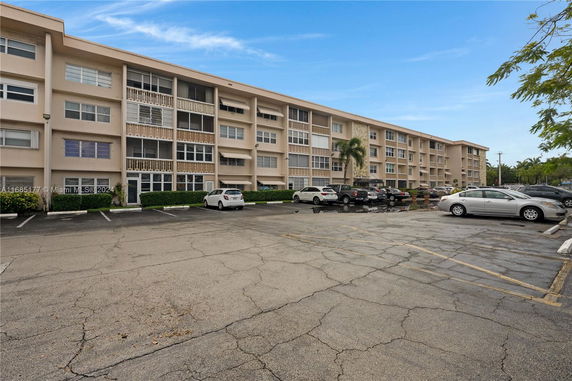 Outdoor parking area in front of a multi-story residential building