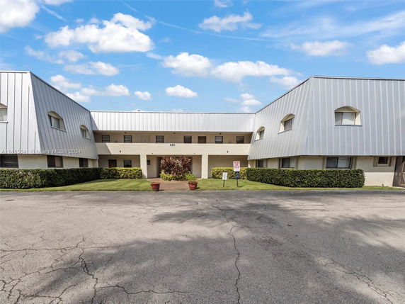 Front view of a two-story building with a metal facade and symmetrical design.