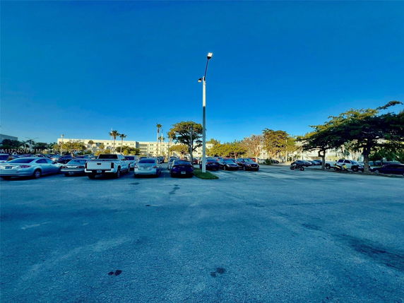 Outdoor parking lot with multiple cars parked.