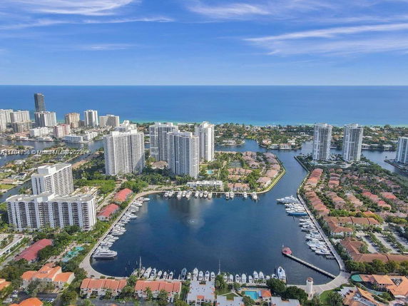Aerial view of high-rise buildings and waterfront area near the ocean.
