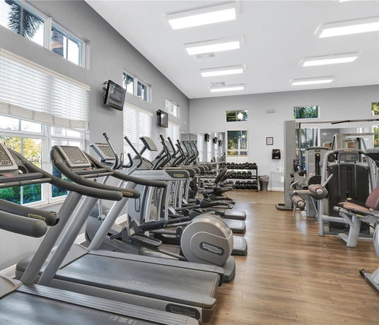 Interior view of a gym room with treadmills and exercise machines.
