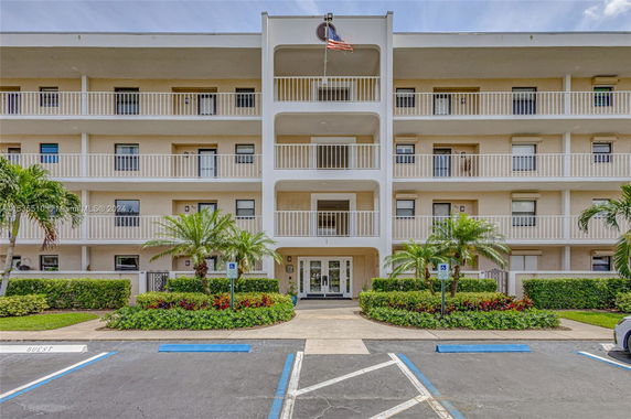 Front view of a multi-story residential building with balconies.
