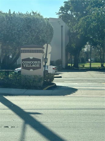 Front view of a building with a sign reading 'Concord Village'.