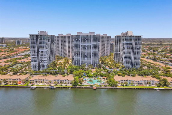 Aerial view of multiple high-rise buildings near a waterfront.
