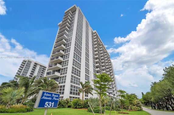 Front view of a high-rise apartment building with balconies.