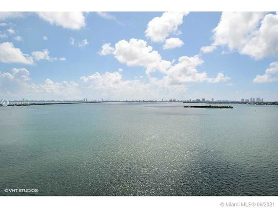 Panoramic view of a large body of water with a distant city skyline.
