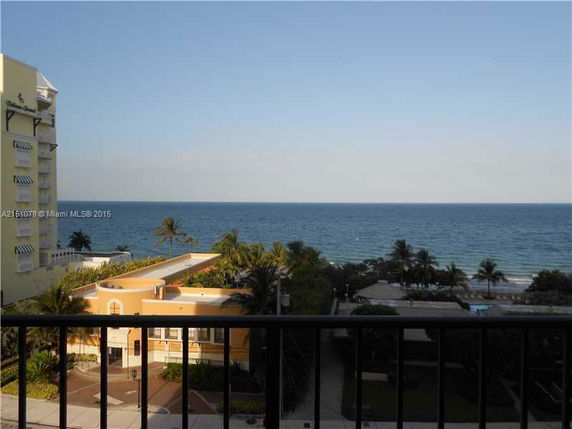 Panoramic view of the ocean from a building with nearby structures visible.