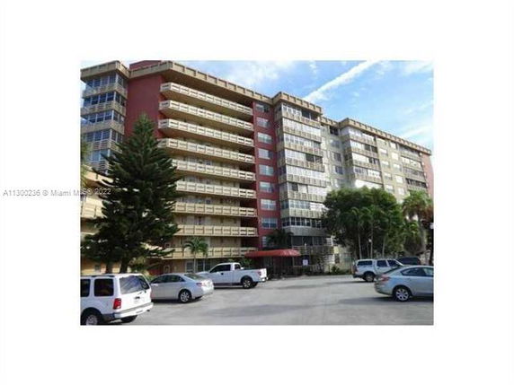 Front view of a multi-story apartment building with balconies.