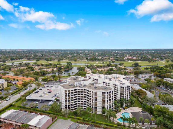 Panoramic view of a multi-story building with surrounding landscape.