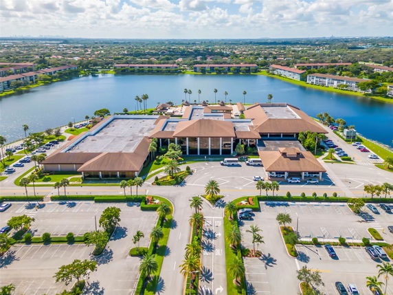 Wide-angle view of a large complex with multiple buildings near a lake.