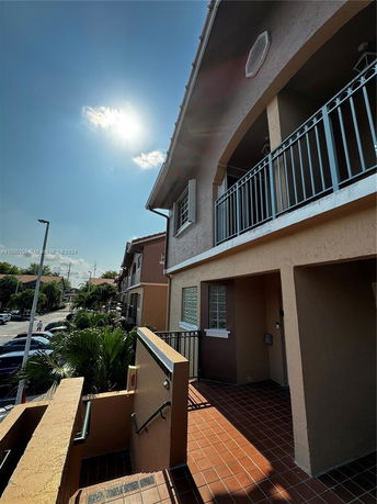 Front view of a multi-story building with balconies.