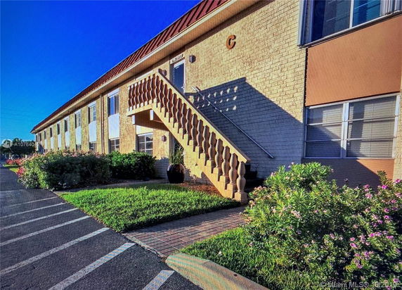 Front view of a two-story building with exterior staircase.